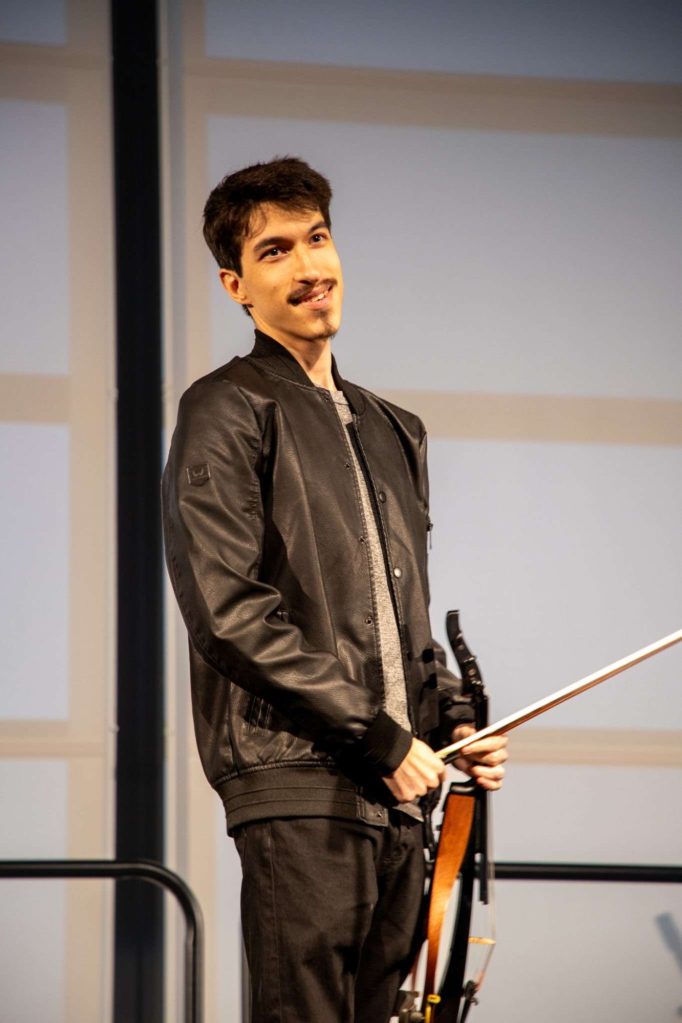 Marcus smiling onstage with his electric violin